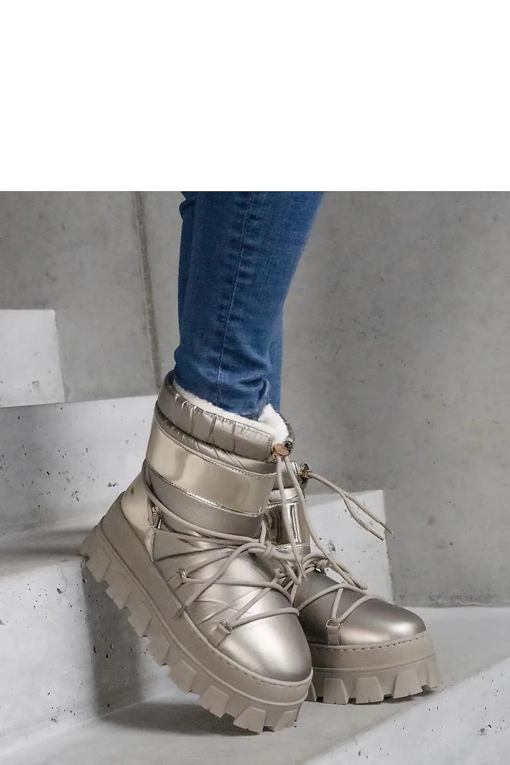 Golden snow boots on a platform