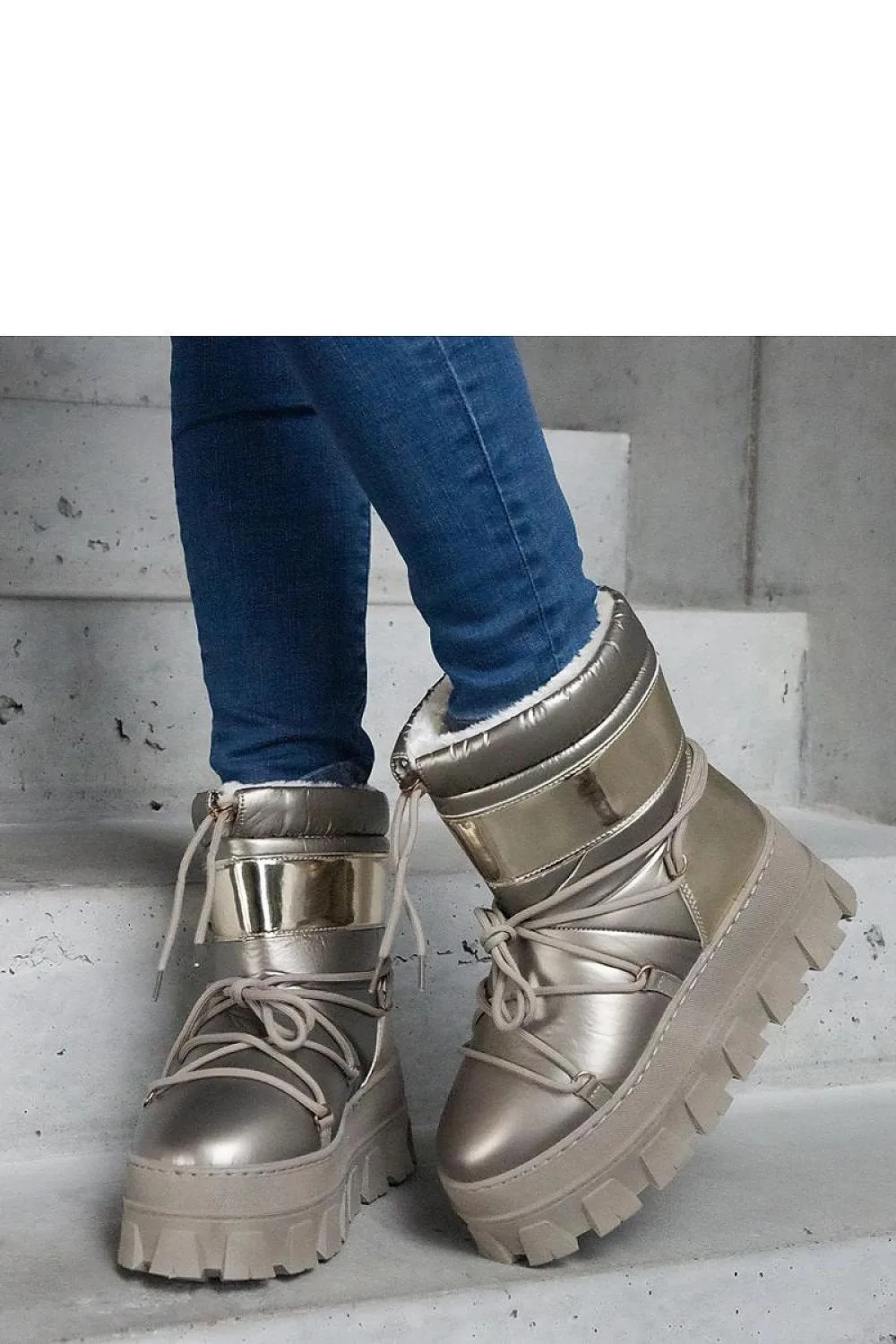 Golden snow boots on a platform